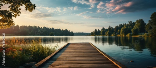 Wooden pier on the lake at sunset. Panoramic view. photo