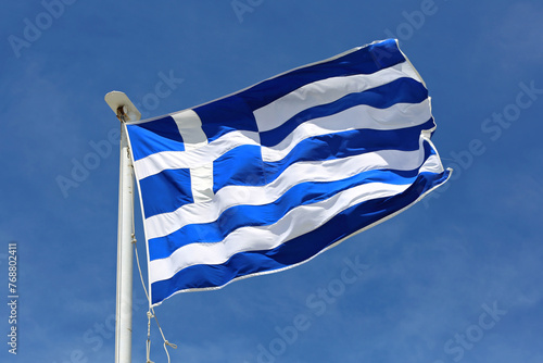 Flag of Greece at Sunny Day Wind Blue Sky