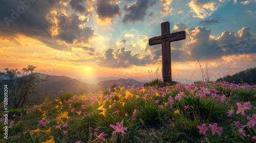 Holy cross the symbol of death and resurrection of Jesus Christ with dramatic sunset over flower field.