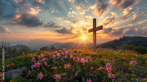 Holy cross the symbol of death and resurrection of Jesus Christ with dramatic sunset over flower field.