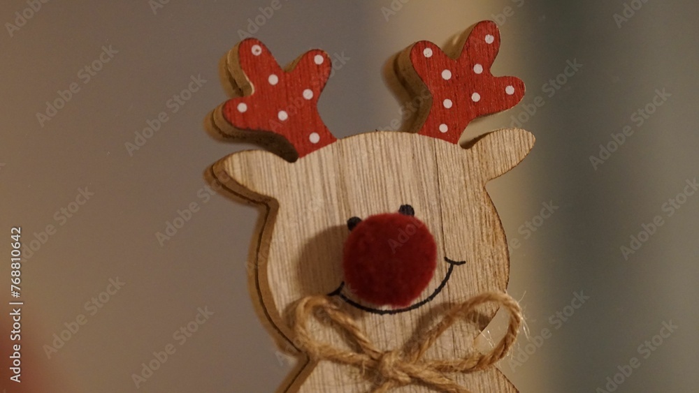 Close-up view of a festive wooden reindeer decoration sitting atop a table