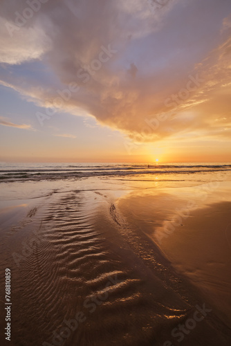 Atlantic ocean sunset with surging waves at Fonte da Telha beach, Costa da Caparica, Portugal