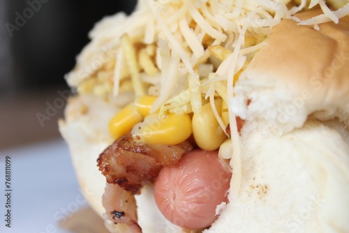 Closeup of a delicious hot dog stuffed with corns and cheese photo