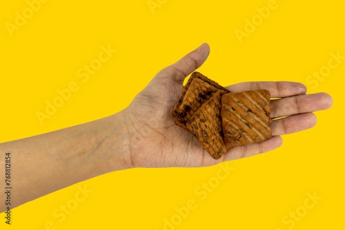 Fototapeta Naklejka Na Ścianę i Meble -  Choco Chips Biscuits Tasty And Yummy On Hand, Isolated on Yellow Background