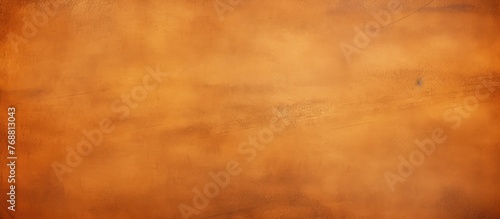 An orange and brown grungy effect dominates this textured background, giving it a worn and aged appearance. The colors blend in a mottled pattern, creating a distressed and rough surface. photo