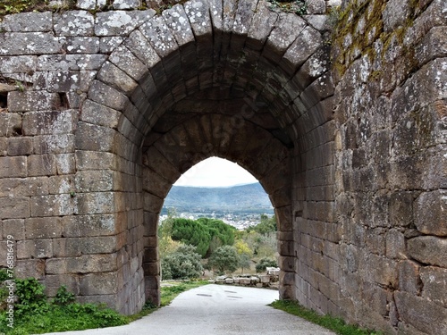 Stunning view of a valley through an aged  stone-built arch. Galicia  Spain.