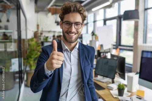 European businessman showing thumbs up in his office, success and achievement concept