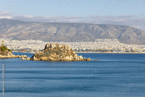 View from Votsalakia Beach of small Koumoundourou island in the Mediterranean Sea, Athens, Piraeus, Greece photo