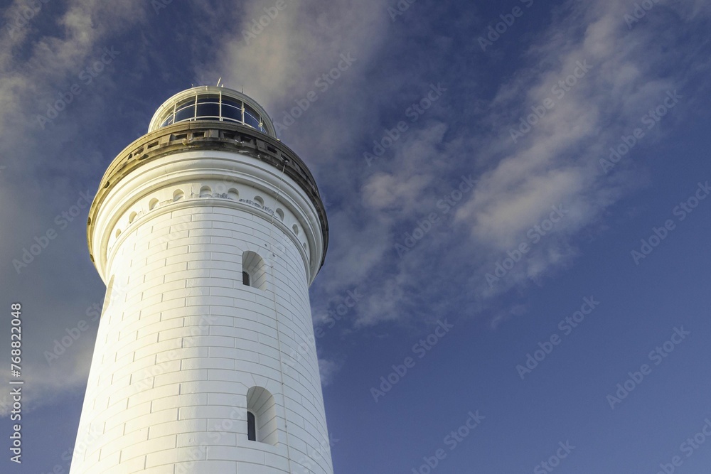 a low angle shot of the Norah Head Lighthouse in australia at sunset