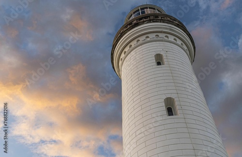 a low angle shot of the Norah Head Lighthouse in australia at sunset