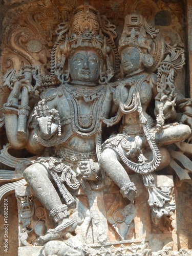 Intricately carved stone statues of Hindu gods adorning the Hoysaleshwara Temple in Halebedu, India