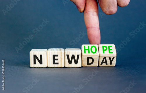 New day and hope symbol. Concept word New day New hope on beautiful wooden cubes. Beautiful grey table grey background. Businessman hand. Business new day and hope concept. Copy space.