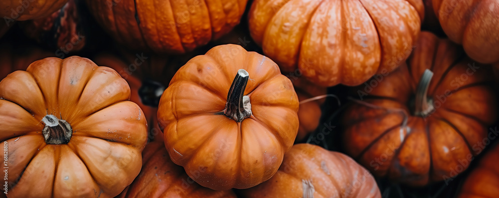 Close-up of a group of vibrant orange pumpkins. Seasonal autumn produce and Halloween decoration concept. Ideal for use in fall-themed designs, food industry marketing, and holiday event promotions. Close-up of a group of vibrant orange pumpkins. Seasonal autumn produce and Halloween decoration concept. Ideal for use in fall-themed designs, food industry marketing, and holiday event promotions.