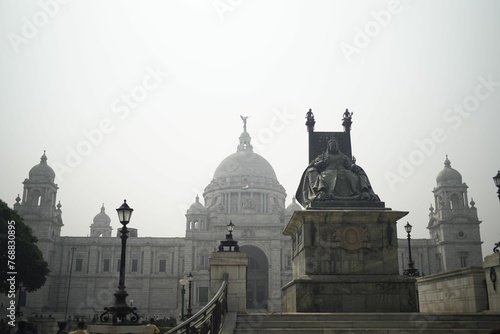 Statue of Queen Victoria in front of the Victoria Memorial architectural building in Kolkata, India.