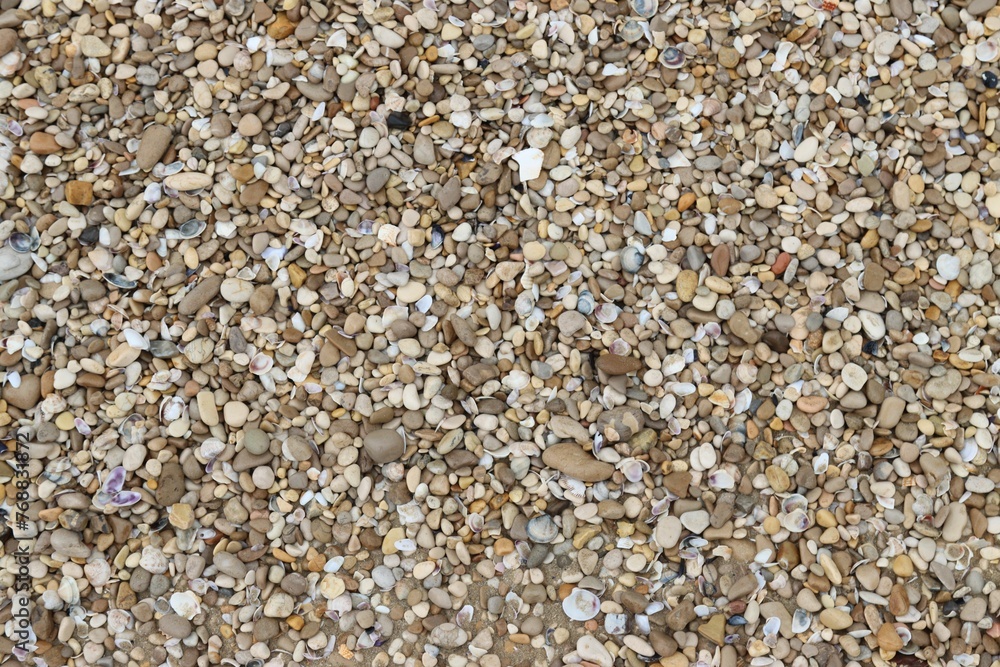 Gravel bed featuring a mix of brown, white and black rocks Gravel bed featuring a mix of brown, white and black rocks