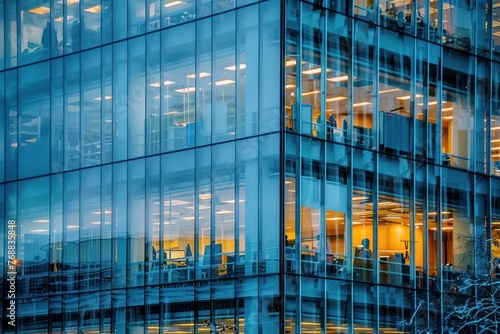 A transparent glass office building with people working