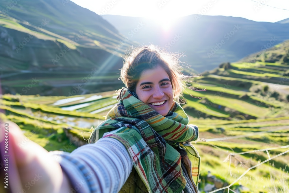 woman with scarf taking a selfie on terraced field