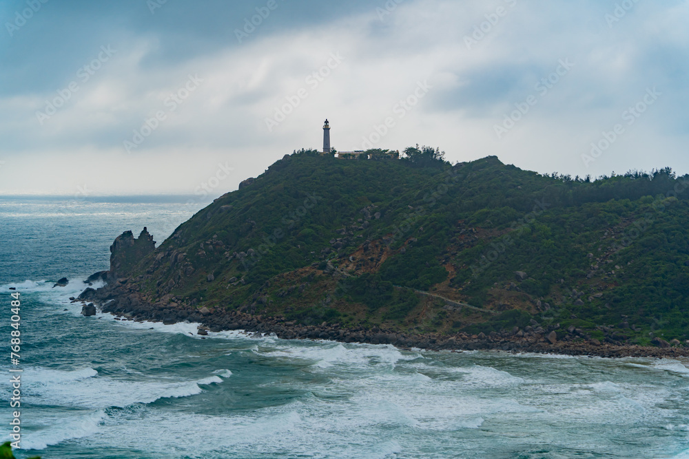 Lighthouse on the mountain.
Cloudy weather, clouds in the sky. Not far from Nha Trang in Vietnam.