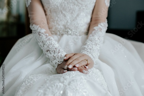 Closeup of a bride displaying her diamond engagement ring.