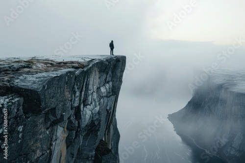 Person standing at the edge of a cliff, business concept