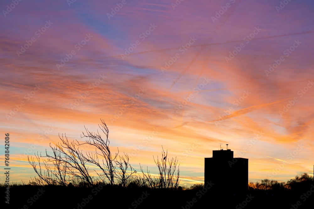 Mesmerizing view of orange sunset over silhouetted city Mesmerizing view of orange sunset over silhouetted city