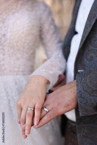 Closeup of the hands of a bride and a groom with wedding rings