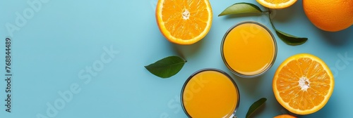 Orange juice on blue background top view
