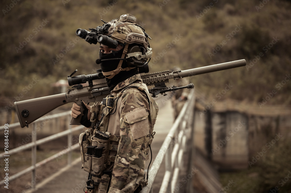 Fototapeta premium Soldiers in camouflage uniforms aiming with their rifles.ready to fire during Military Operation in the forest , soldiers training in a military operation