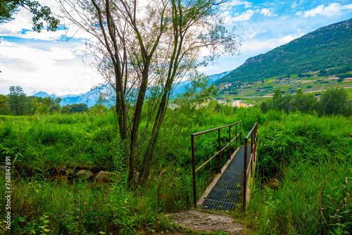 River with a Bridge and with Mountain View and Clouds in a Sunny Day Granges  Valais in Switzerland.