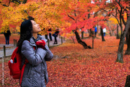Woman enjoying the colorful Japanese autumn