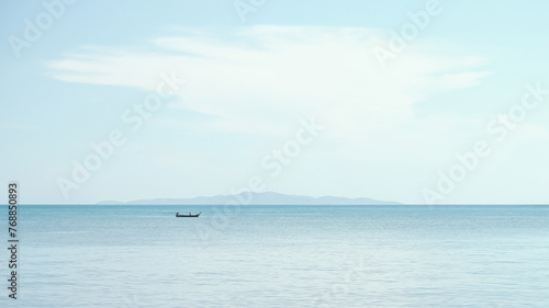 A small boat of fisherman floats in the the sea.
