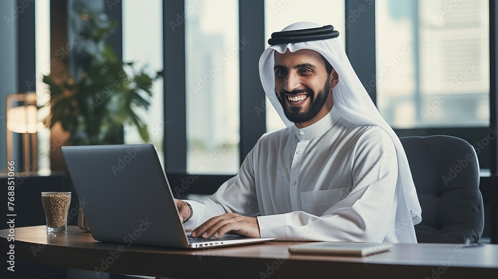 Arab businessman working on laptop computer in modern office Arab businessman working on laptop computer in modern office