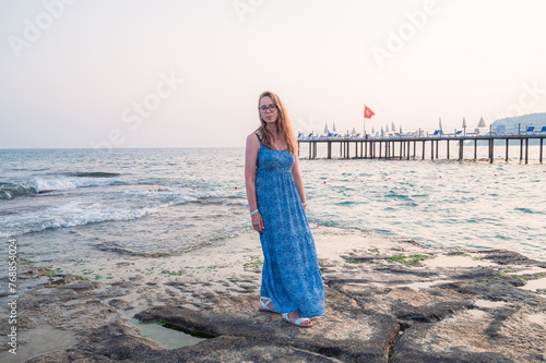 Woman sits on the beach and...