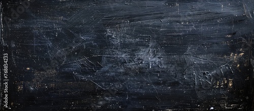 A black and white composition against a black background, showcasing textured details reminiscent of an old blackboard or chalkboard wall.