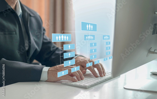 Delegate concept with businessman using computer to  setting an abstract employee hierarchy pictogram, company organization chart, HR Job.