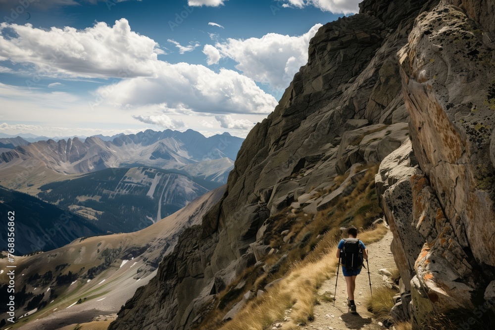 hiker navigating a narrow mountain trail with caution hiker navigating a narrow mountain trail with caution