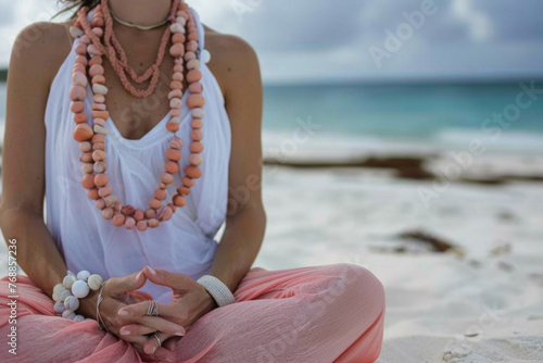 Close up of a woman sitting on the beach mediating photo