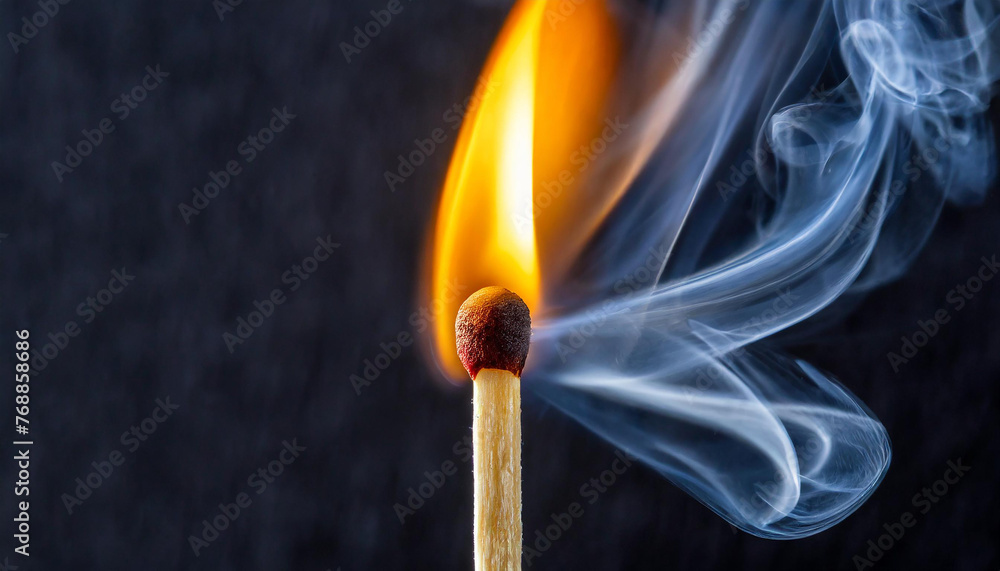 Close-up of burning wooden match on black background. Match head with hot orange flame and smoke. Close-up of burning wooden match on black background. Match head with hot orange flame and smoke.