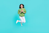 Full body portrait of pretty excited person hold telephone enjoy free time isolated on teal color background