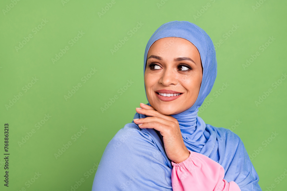 Profile side photo of arabian woman arm touch chin minded thoughtful look empty space isolated over green color background Profile side photo of arabian woman arm touch chin minded thoughtful look empty space isolated over green color background