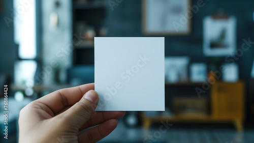 Someone holding a blank card in their hand in a living room, Virtual Design. Generated AI 