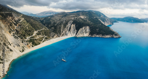 Luxury Sail Yacht in Myrtos beach with blue bay on Kefalonia Island, Greece. Aerial panoramic photo