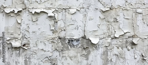 A monochrome texture on an old concrete wall, showing areas where white and gray paint have been applied. The paint appears worn and weathered, adding character to the wall.