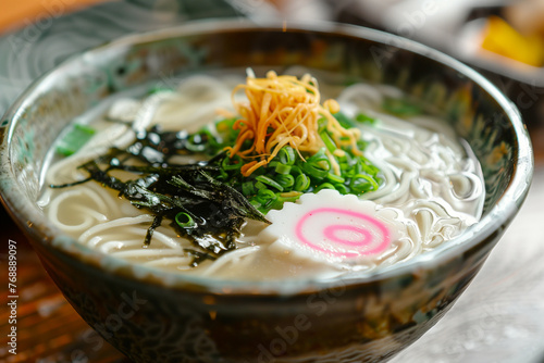 A sumptuous serving of authentic Japanese ramen, featuring silky noodles, savory broth, seaweed, and a pink-swirled narutomaki photo