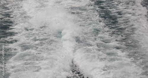 Ship wake up in the ocean. aves from the back of a speed boat over the water's surface in the sea. Waves behind a boat on a clear blue sea