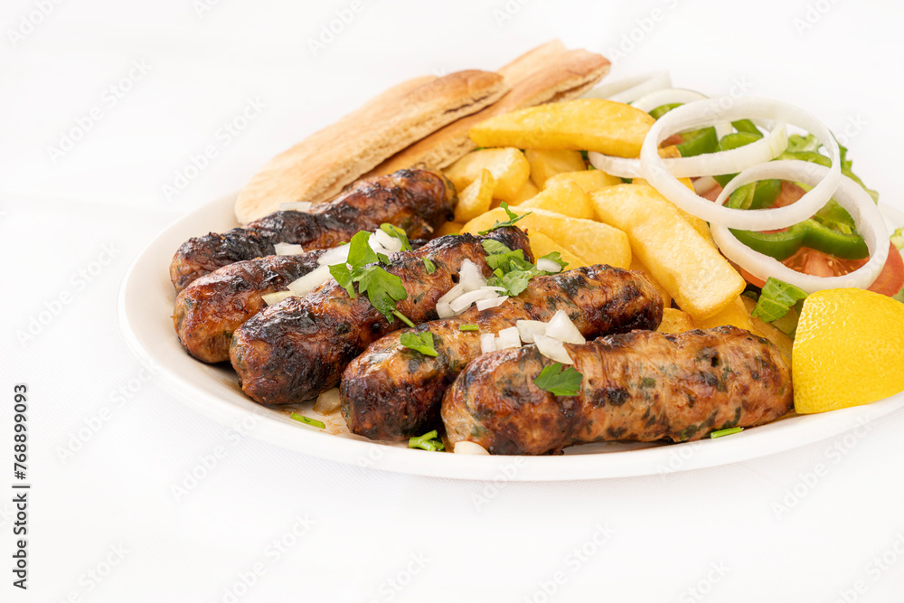 Cypriot Seftalia meal with fries and salad