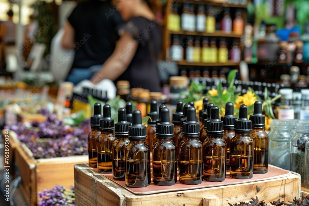 essential oils display at a market with a seller
