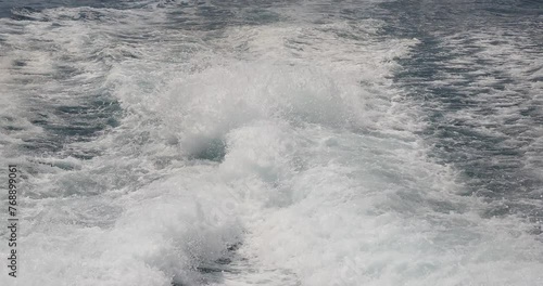 Ship wake up in the ocean. aves from the back of a speed boat over the water's surface in the sea. Waves behind a boat on a clear blue sea