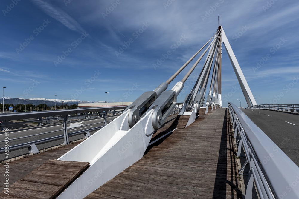 Bridge with pedestrian walkway and vehicle lanes with metal braces to support the structure