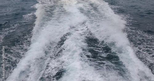 Ship wake up in the ocean. aves from the back of a speed boat over the water's surface in the sea. Waves behind a boat on a clear blue sea